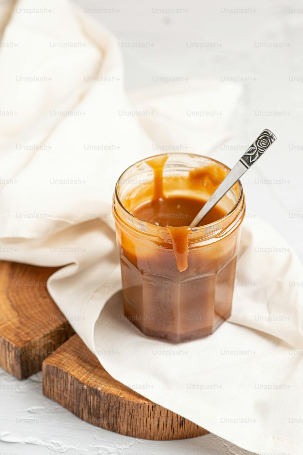 a jar of caramel sauce with a spoon in it