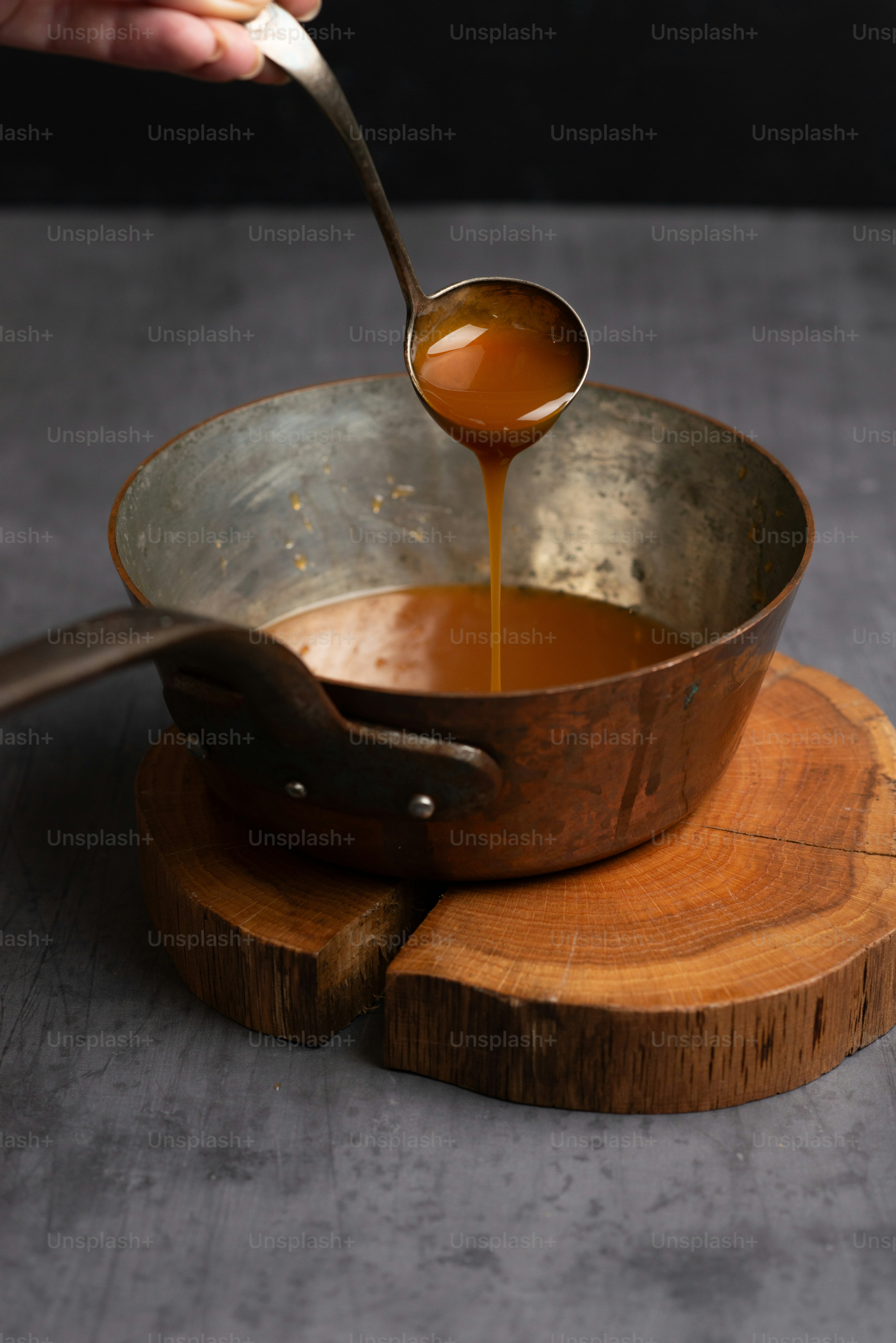 une personne met une sauce dans une casserole
