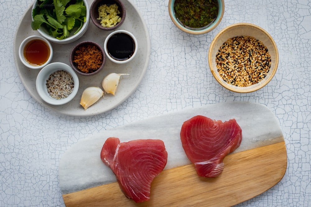 two raw fish fillets sit on a cutting board