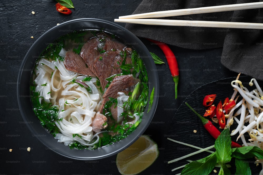 a bowl of soup with noodles, meat and vegetables