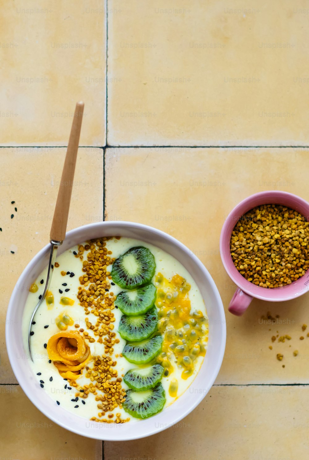a bowl of yogurt with kiwi slices and seeds