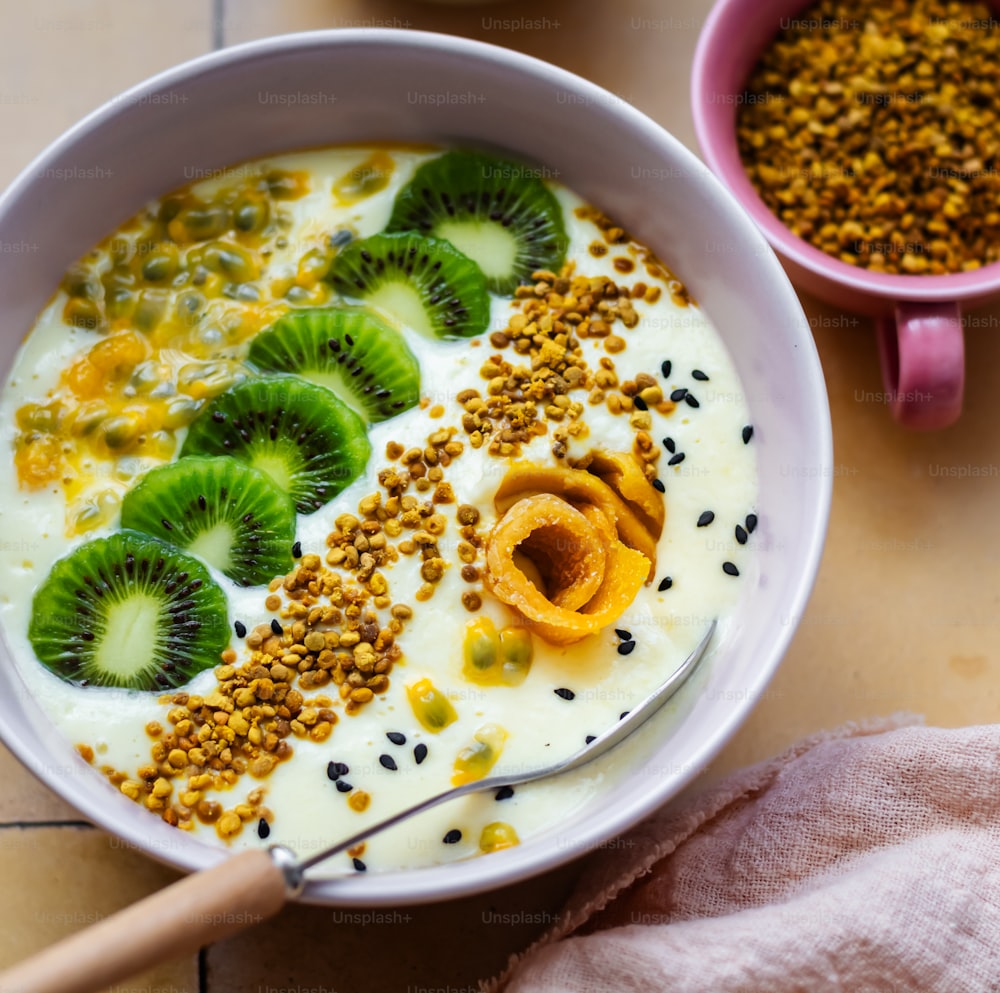 a bowl of cereal with kiwis and seeds