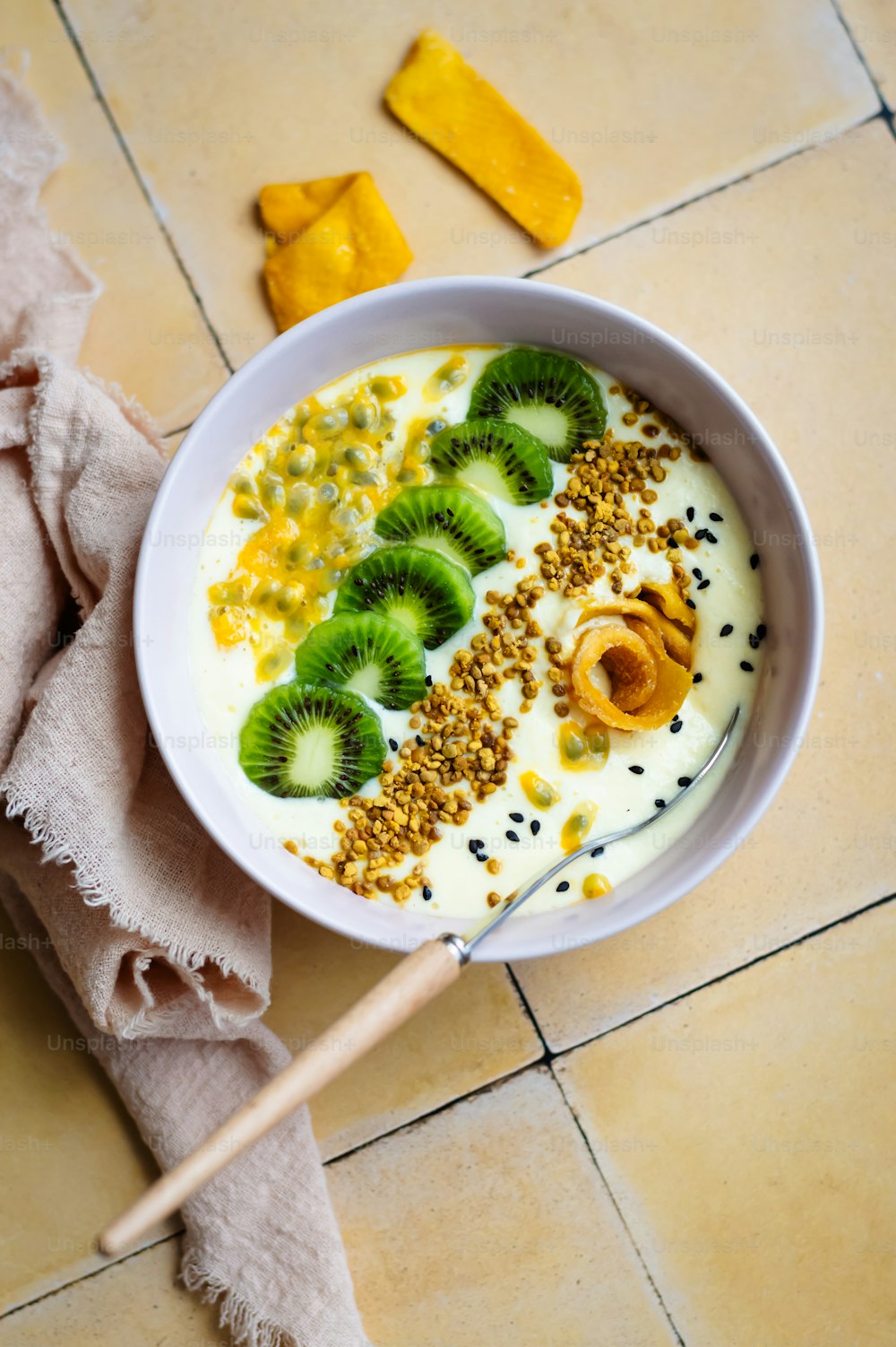 a bowl of yogurt with kiwis and nuts