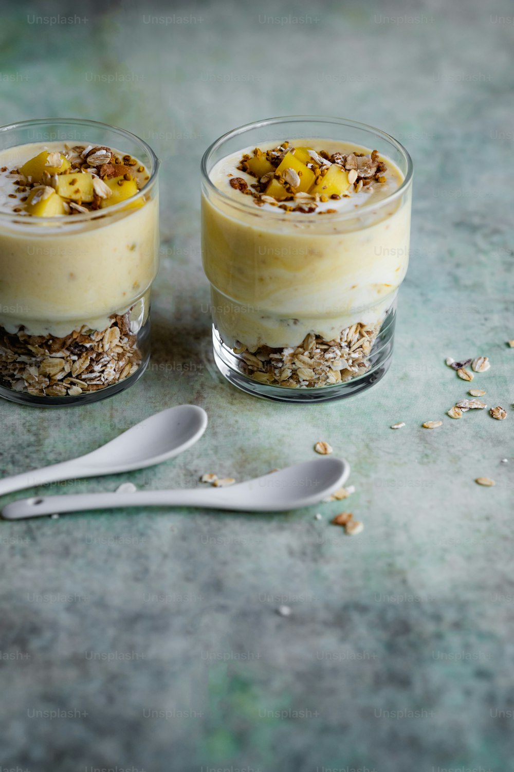 two desserts with oats and granola on a table