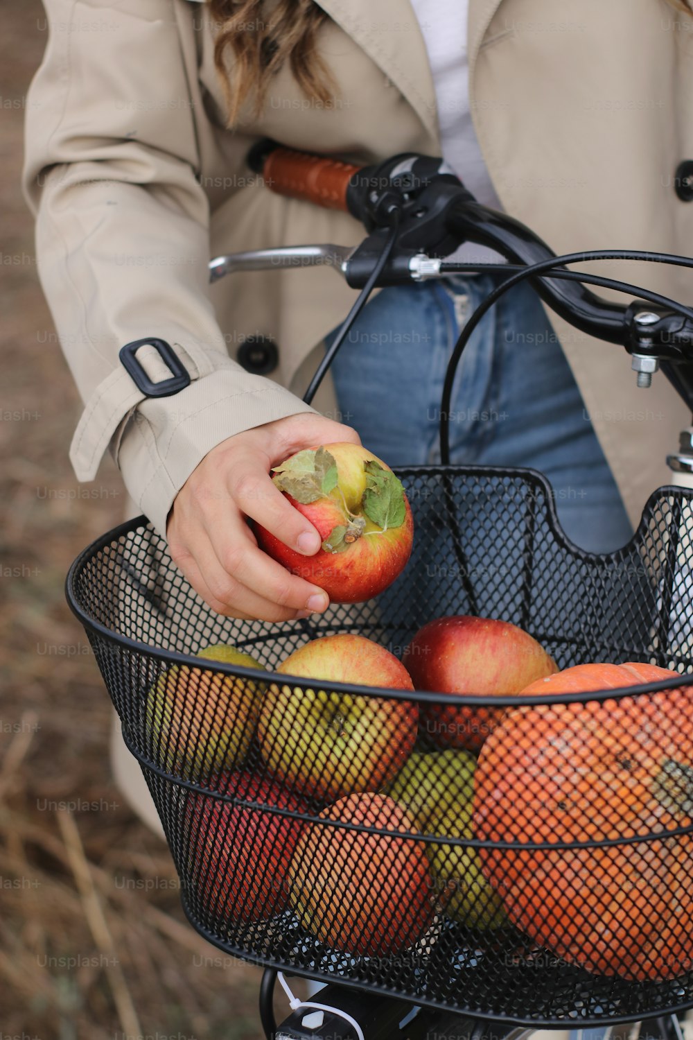 a woman holding a basket full of apples