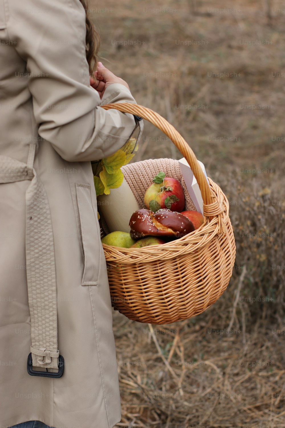 a woman holding a basket full of food