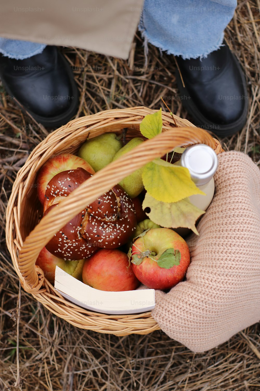a person holding a basket full of apples