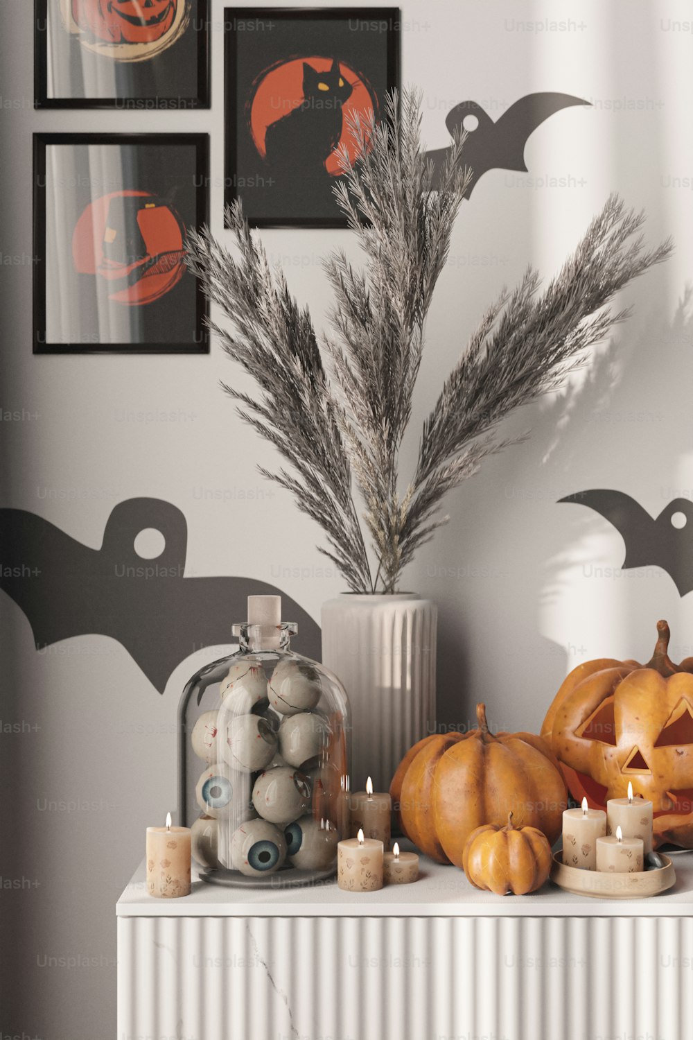 a white mantle topped with lots of halloween decorations