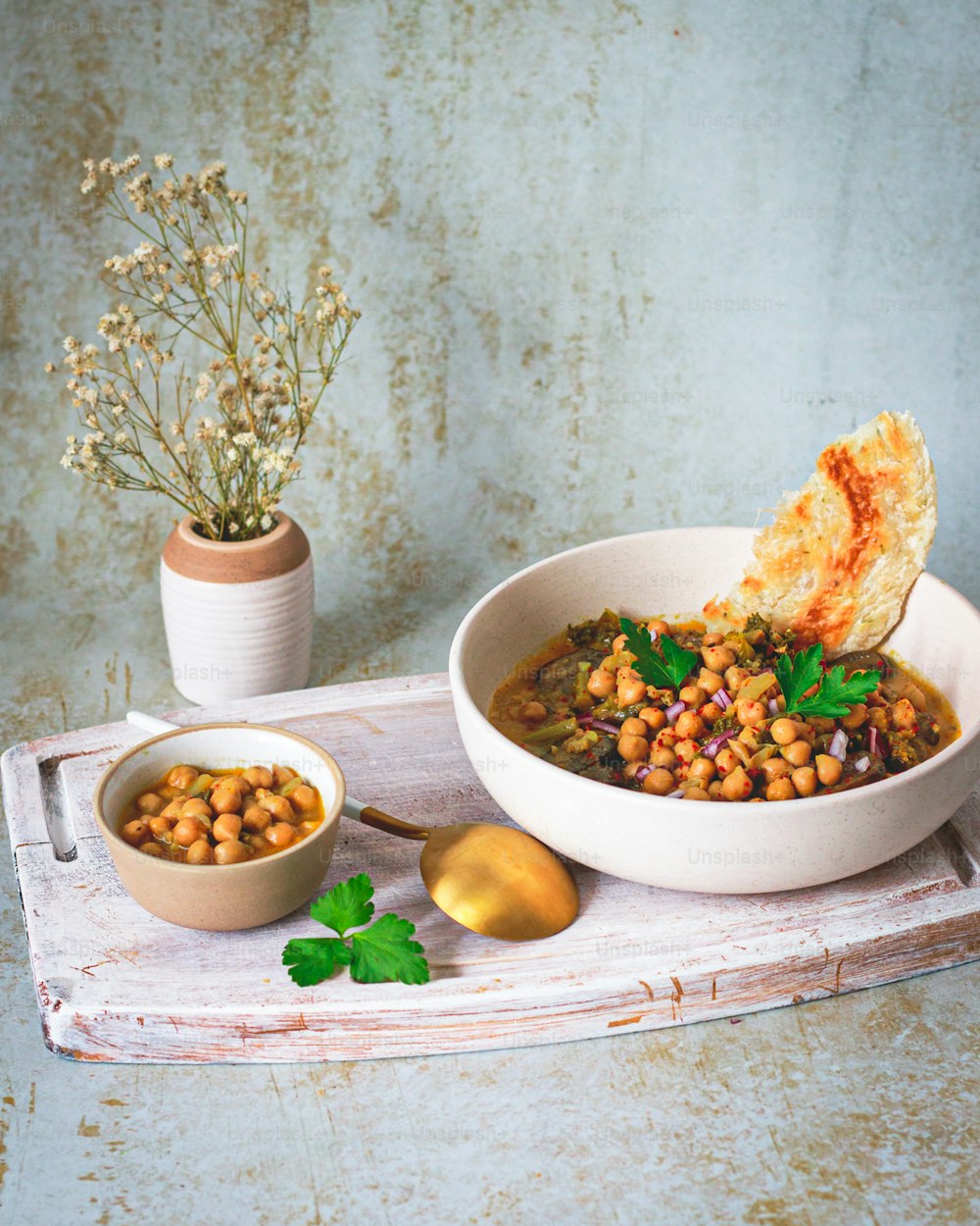 a bowl of beans and bread on a tray