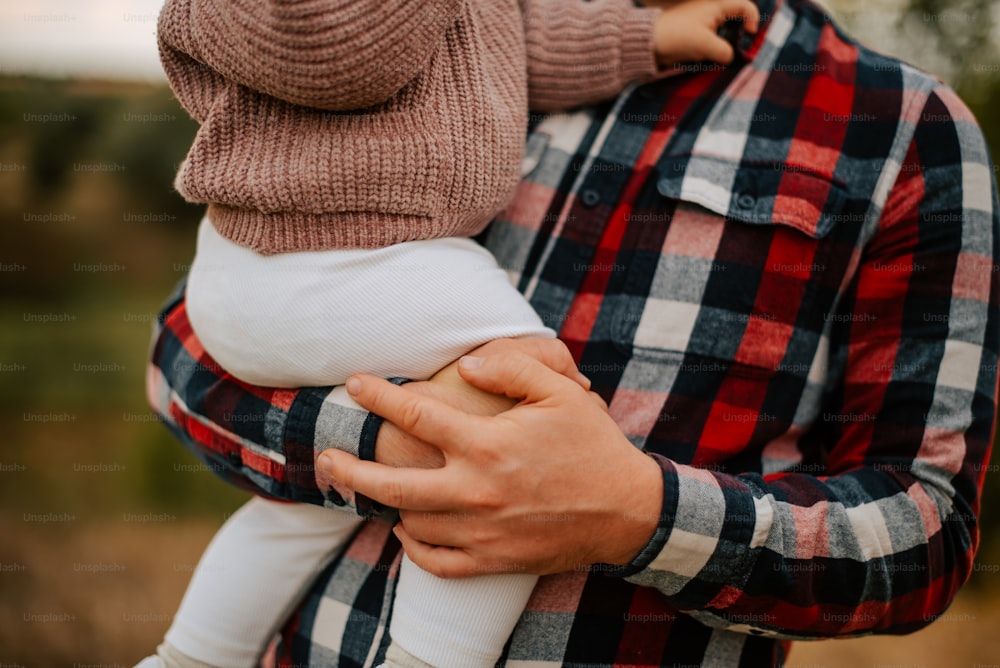 a man holding a baby in his arms