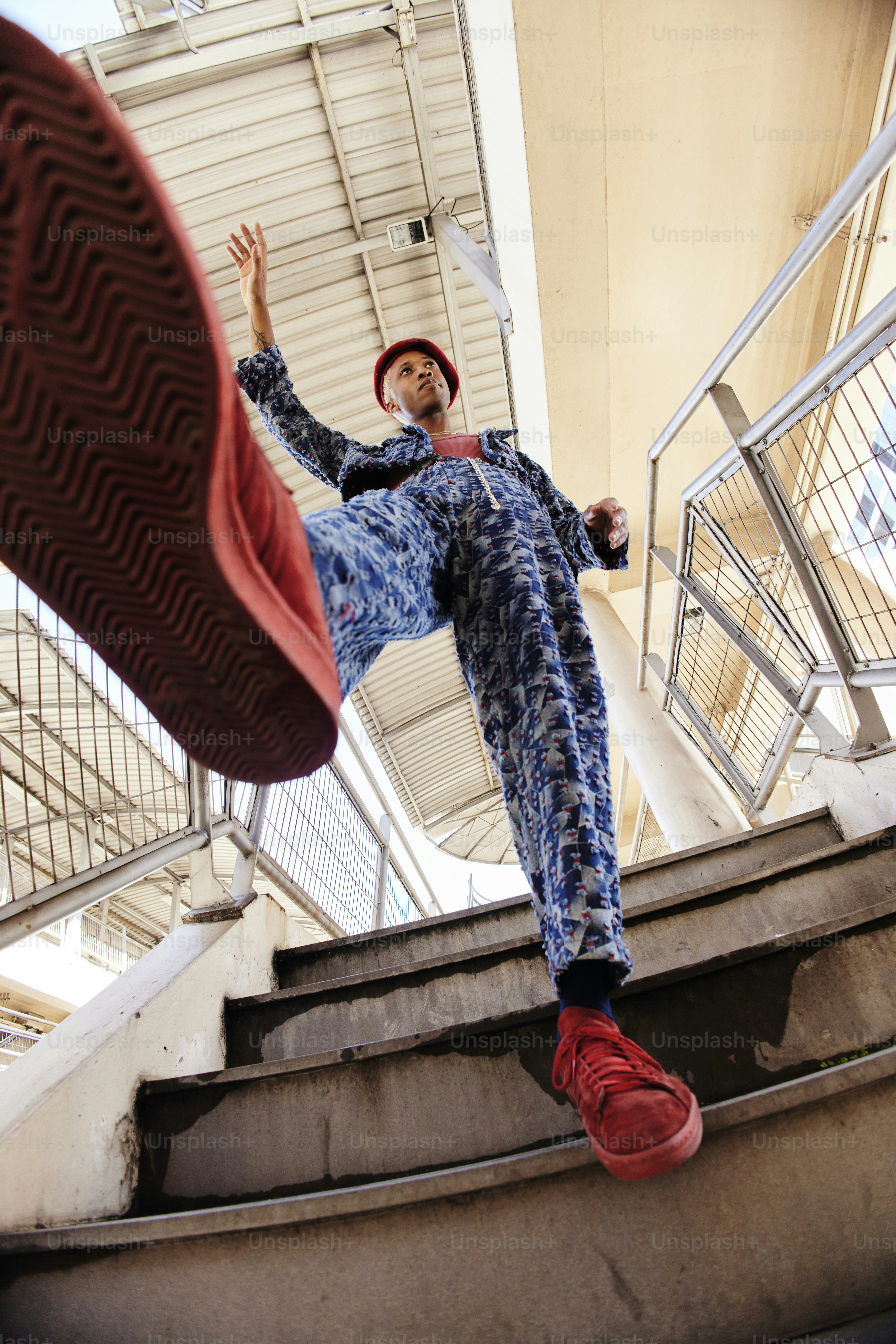 a man riding a skateboard down the side of a flight of stairs