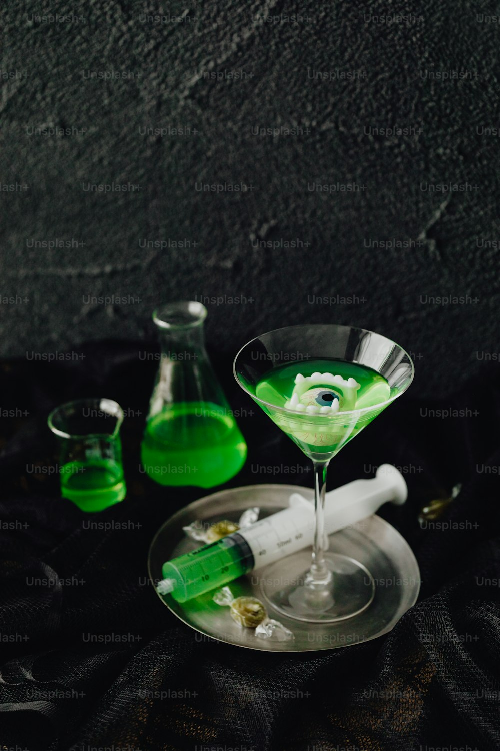 a green liquid in a martini glass