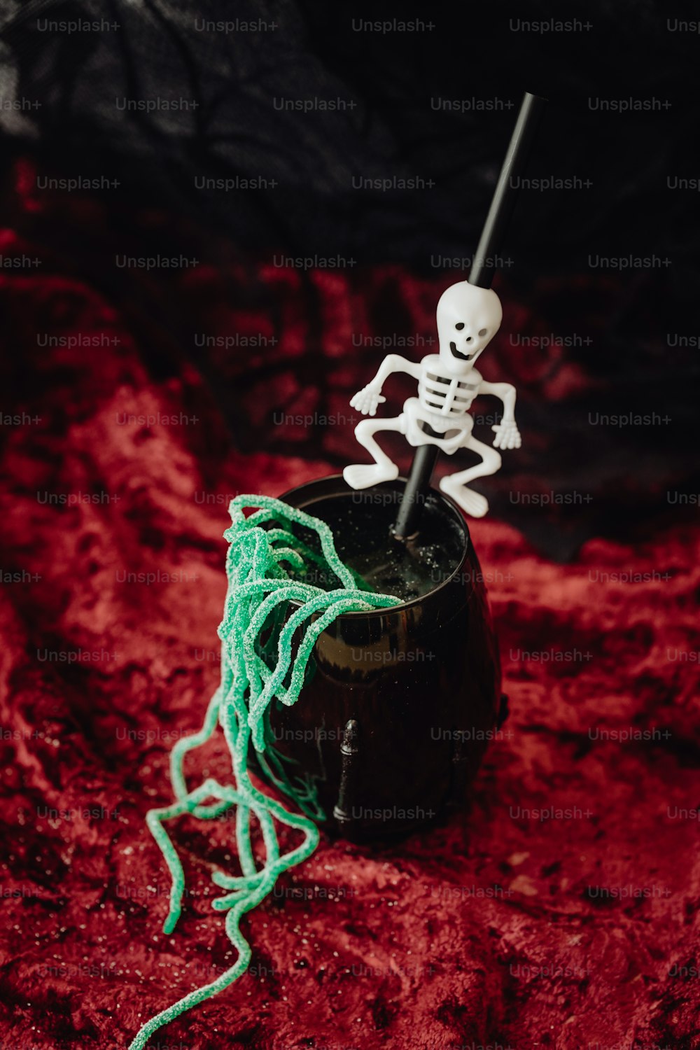 a spool of green yarn with a skeleton on top of it