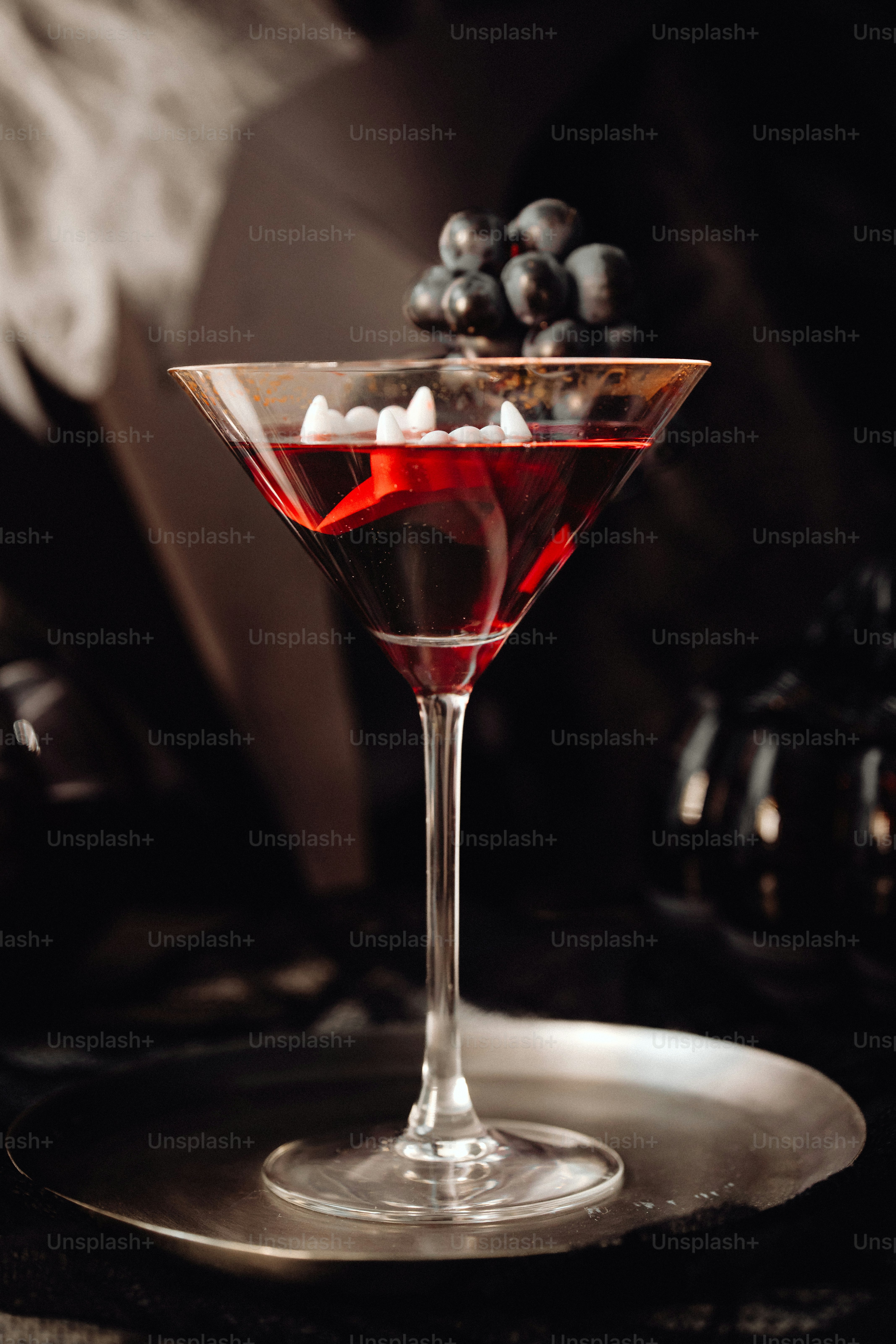 a glass filled with liquid and ice on top of a table