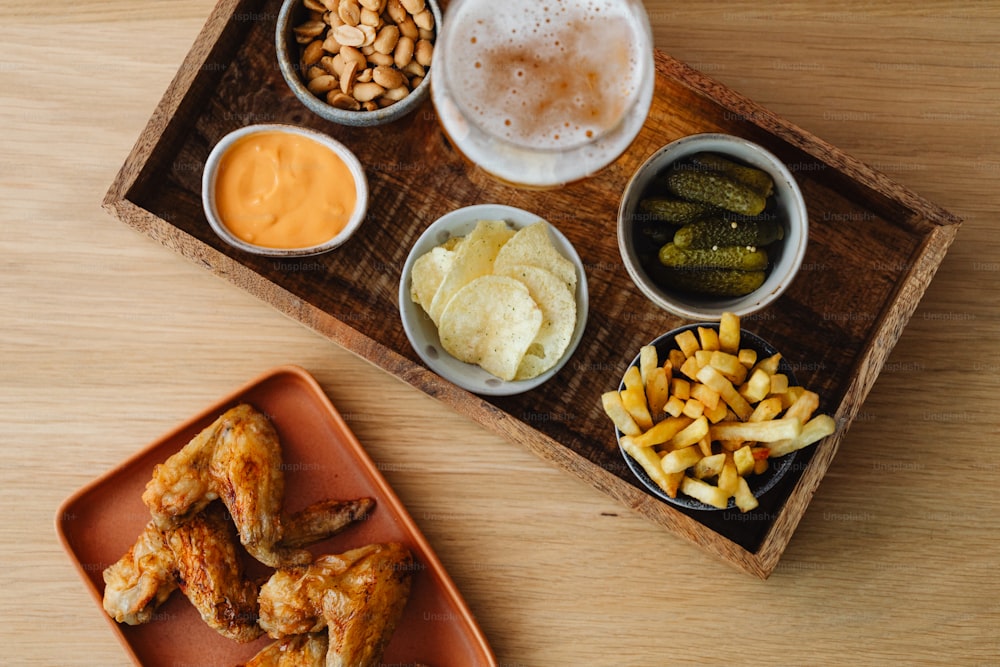 a wooden tray topped with different types of food