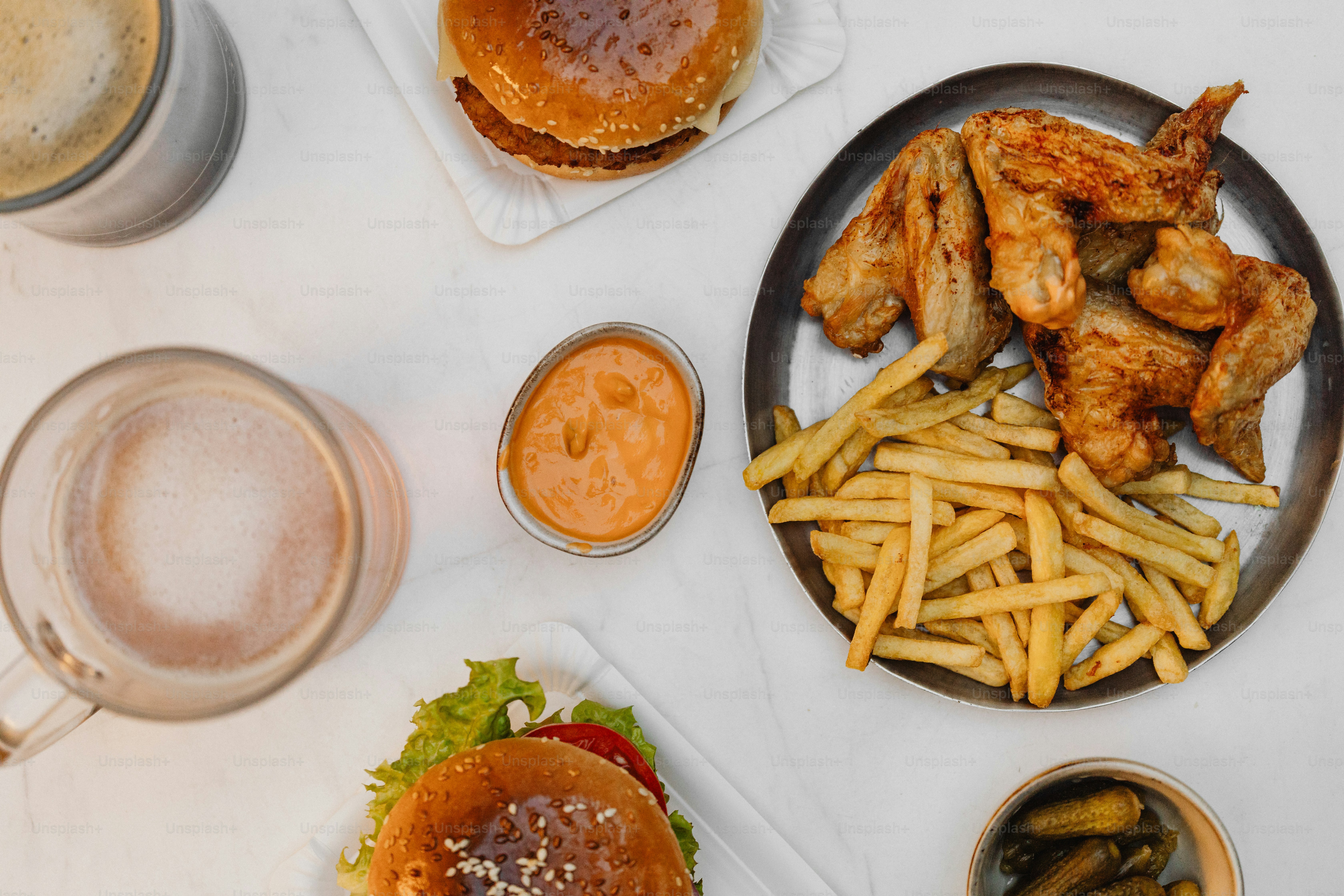 a table topped with plates of food and drinks
