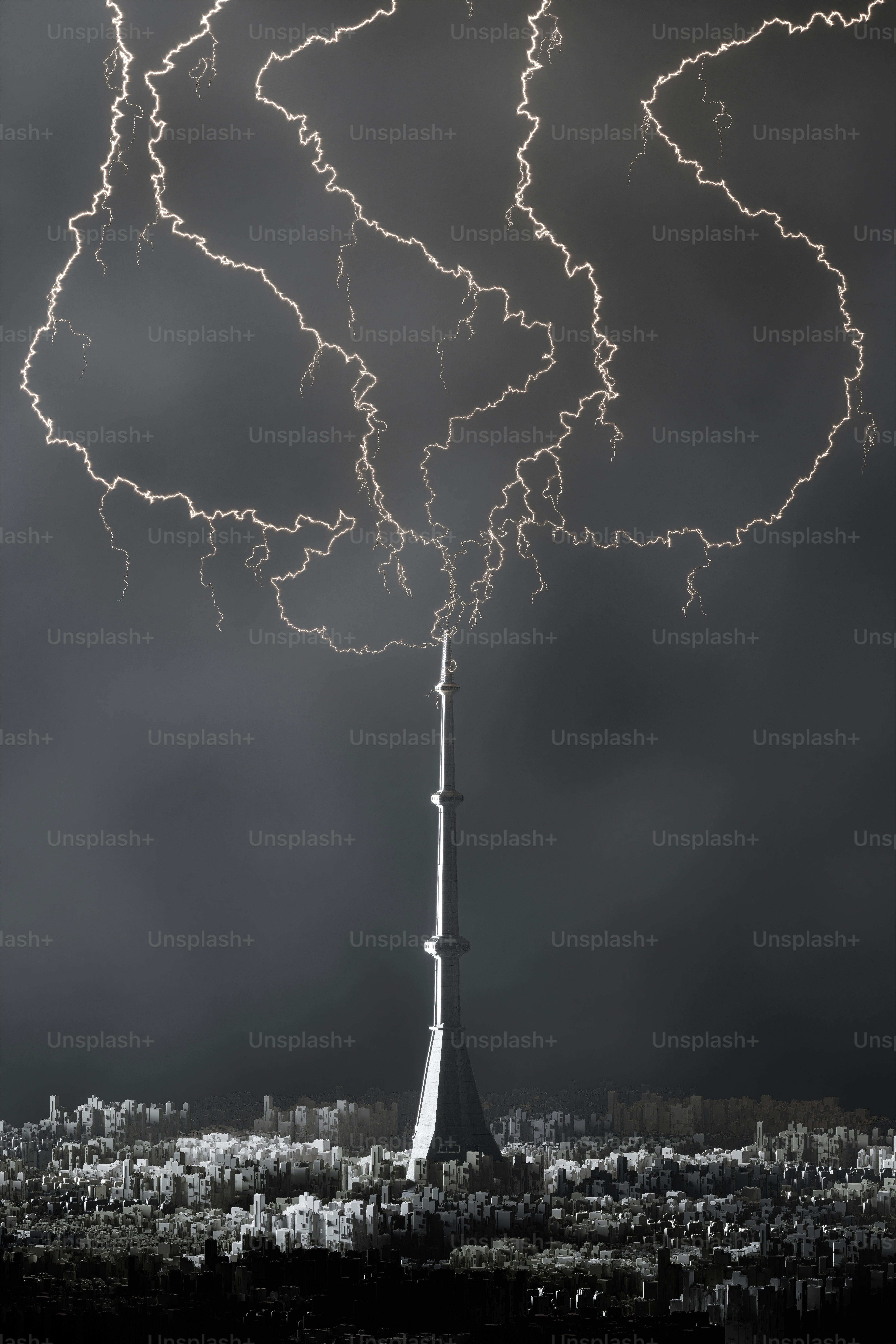 a black and white photo of a tower with a lot of clouds