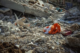 a stuffed animal laying on top of a pile of rubble