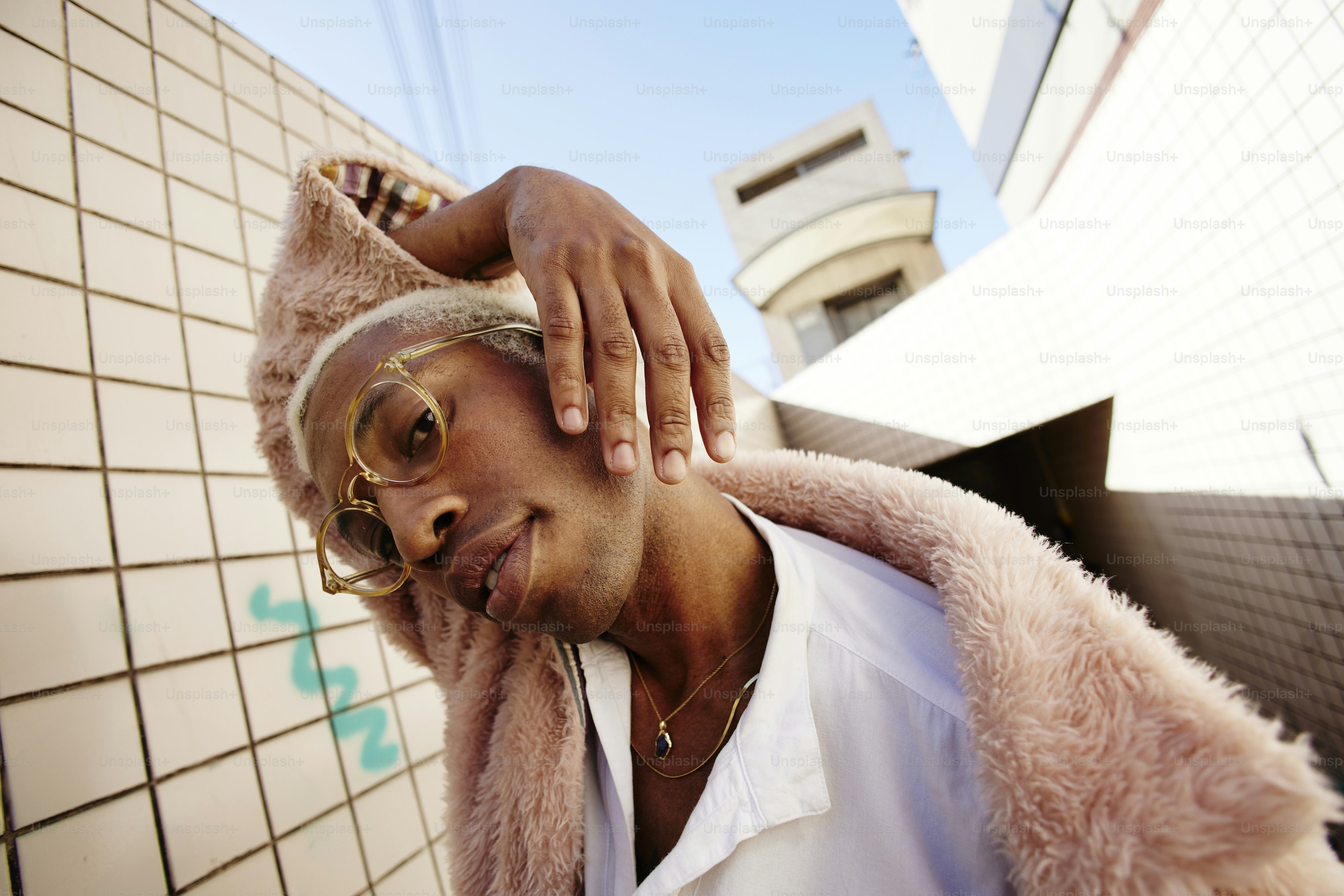 a man in a white shirt and a pink fur coat