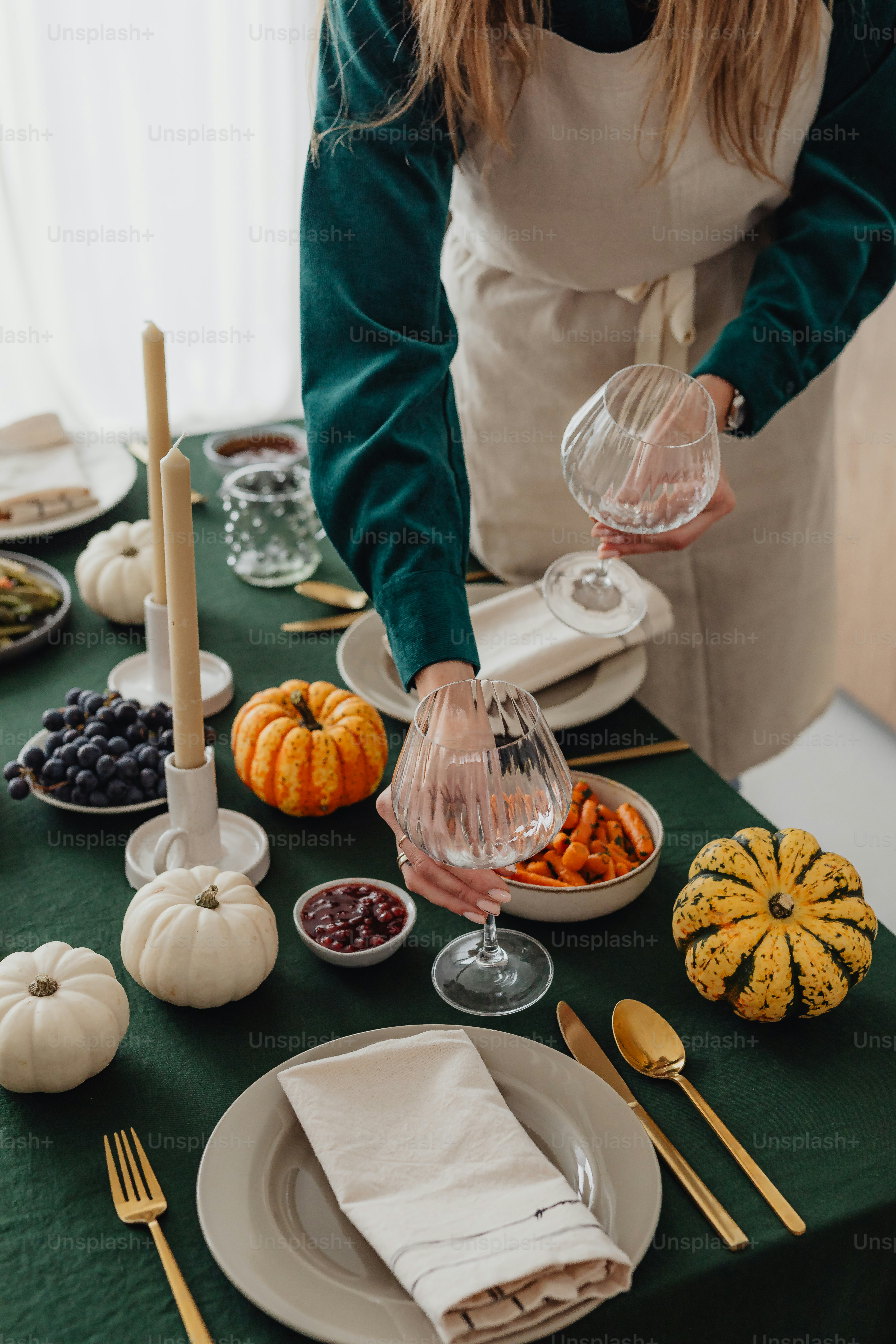 a woman in an apron preparing food on a table