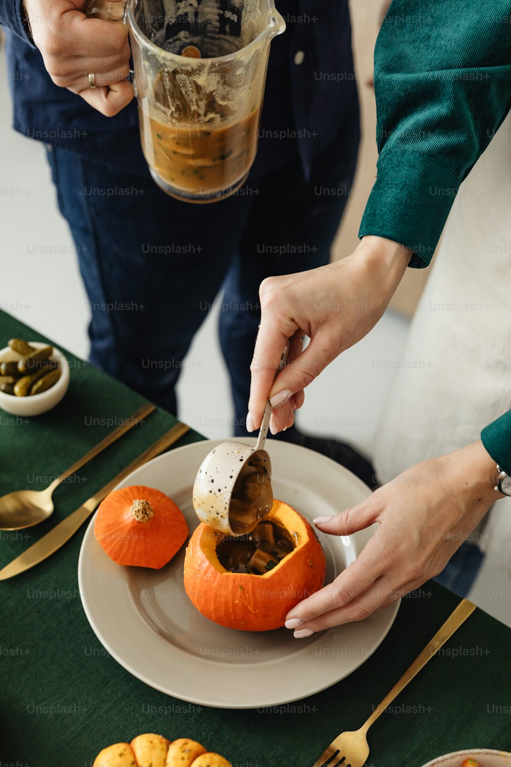 a person cutting into a pumpkin on a plate