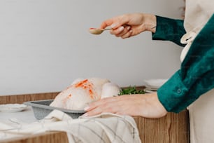 a woman holding a spoon over a plate of food