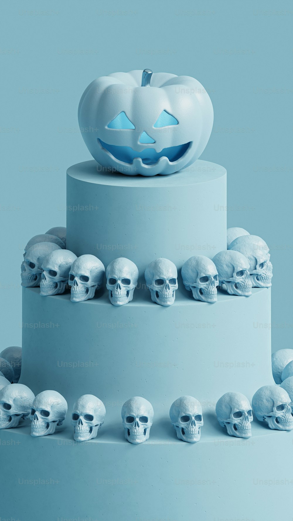 a three tiered cake with skulls and a pumpkin on top