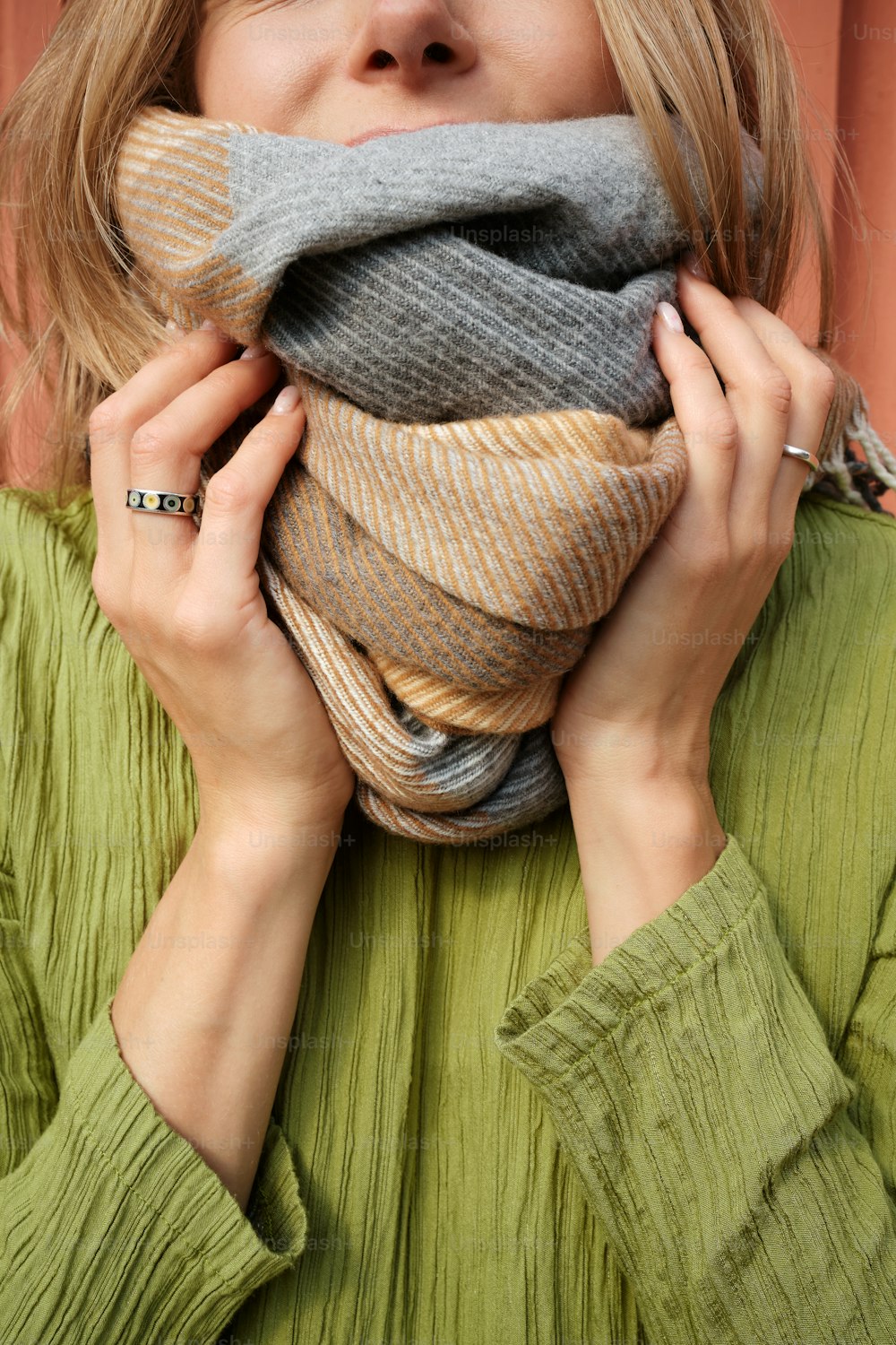 a woman covering her face with a scarf