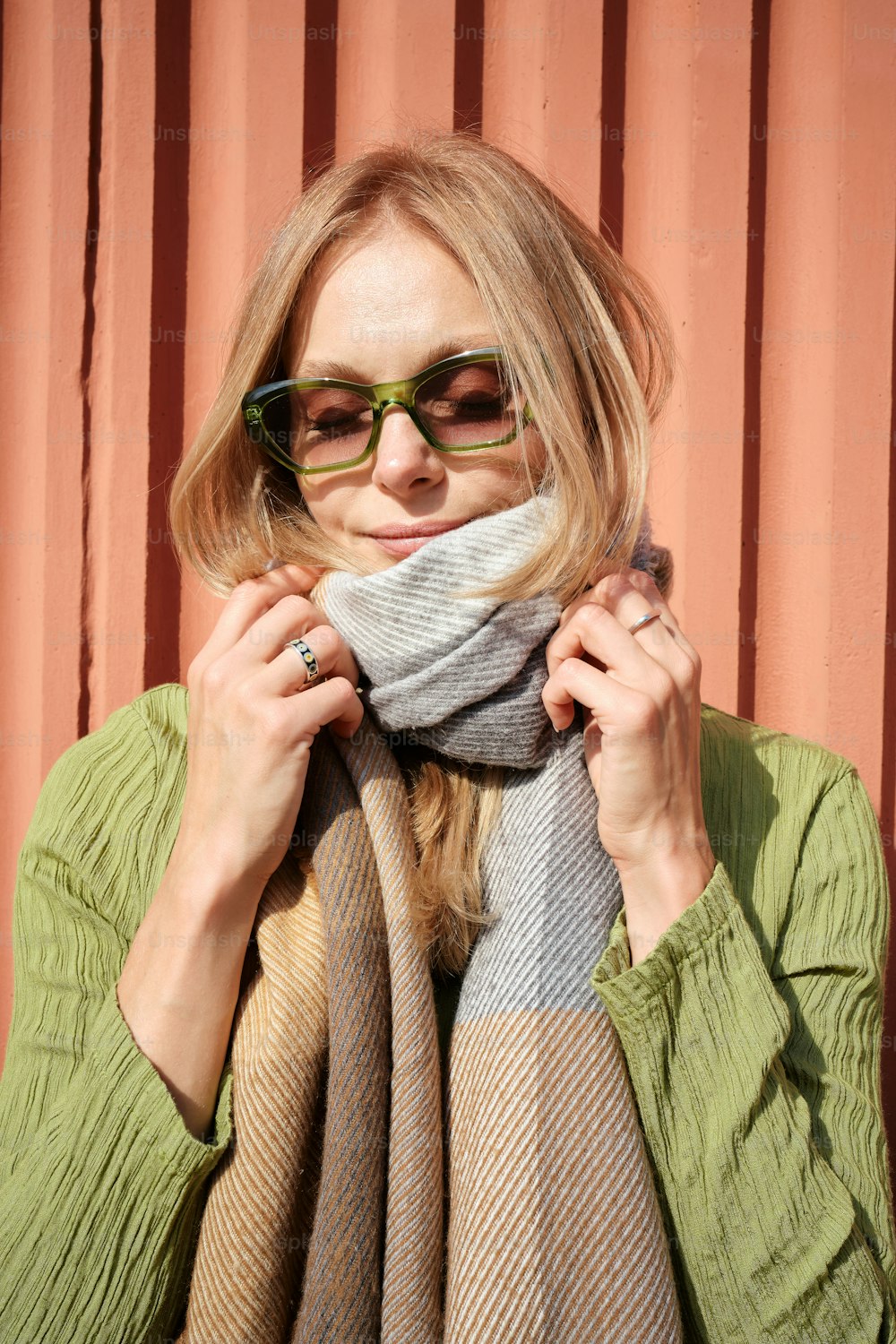 a woman wearing glasses and a scarf around her neck
