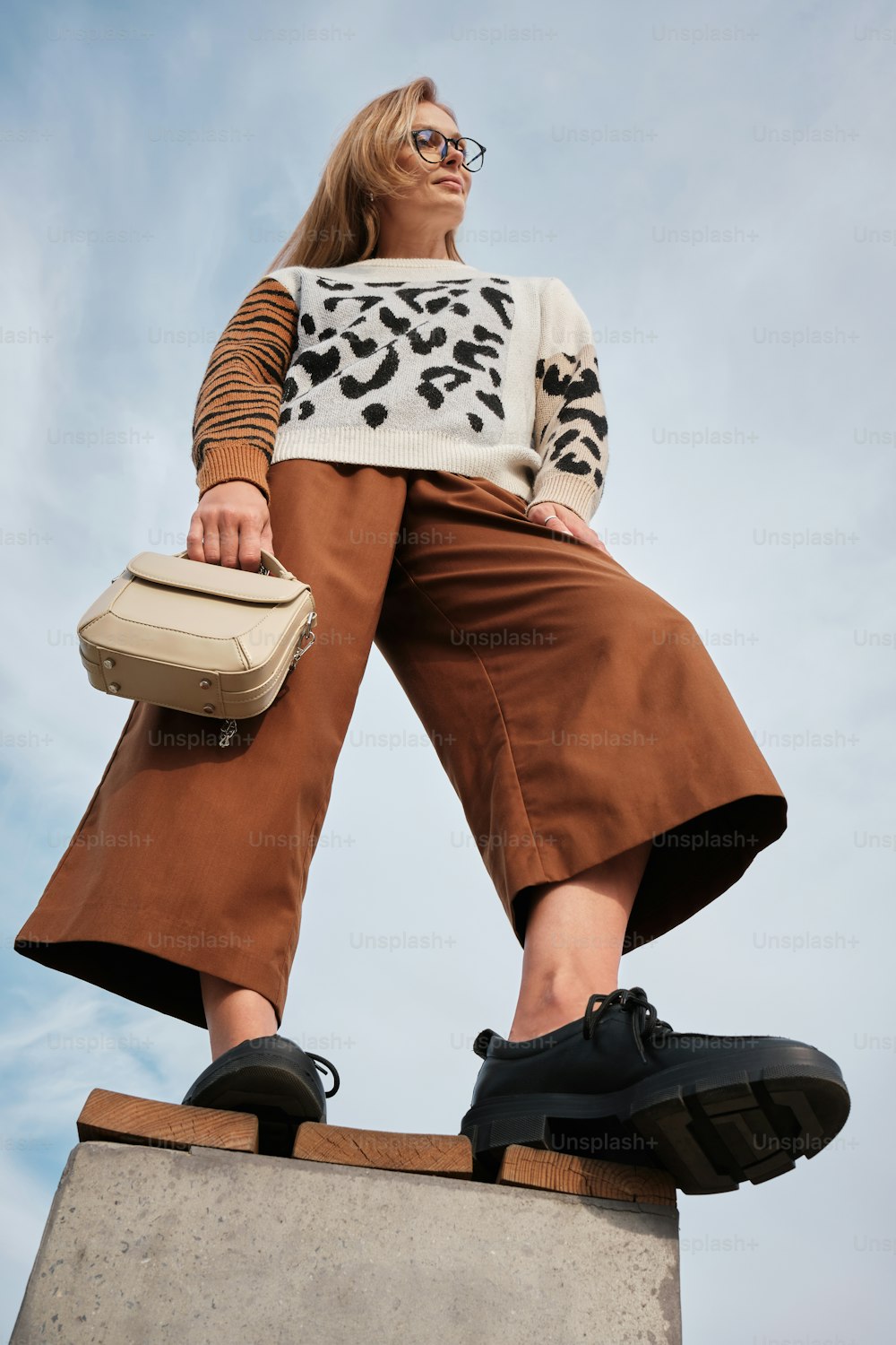 a woman standing on top of a cement block