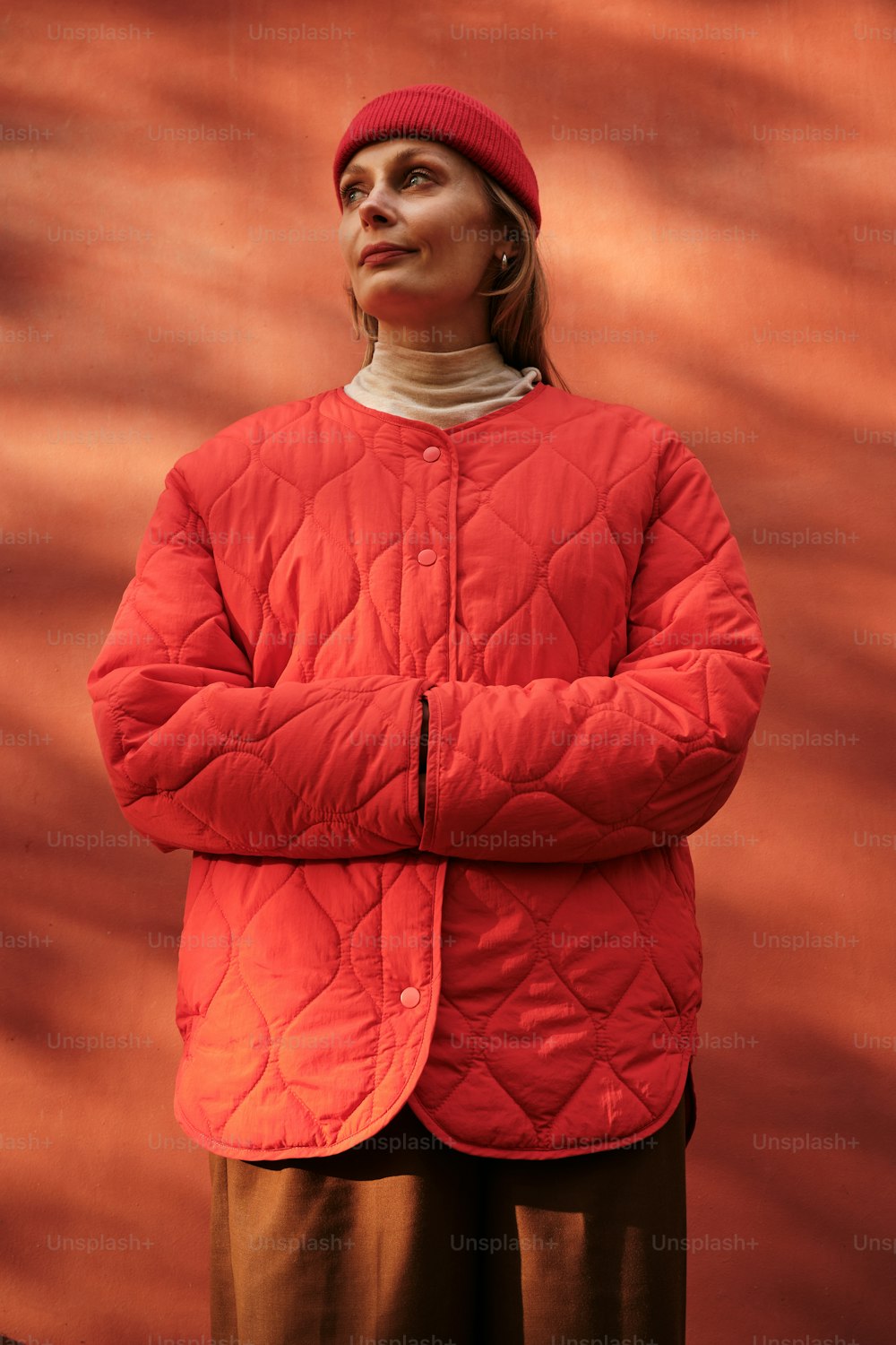 a woman wearing a red jacket and a red hat