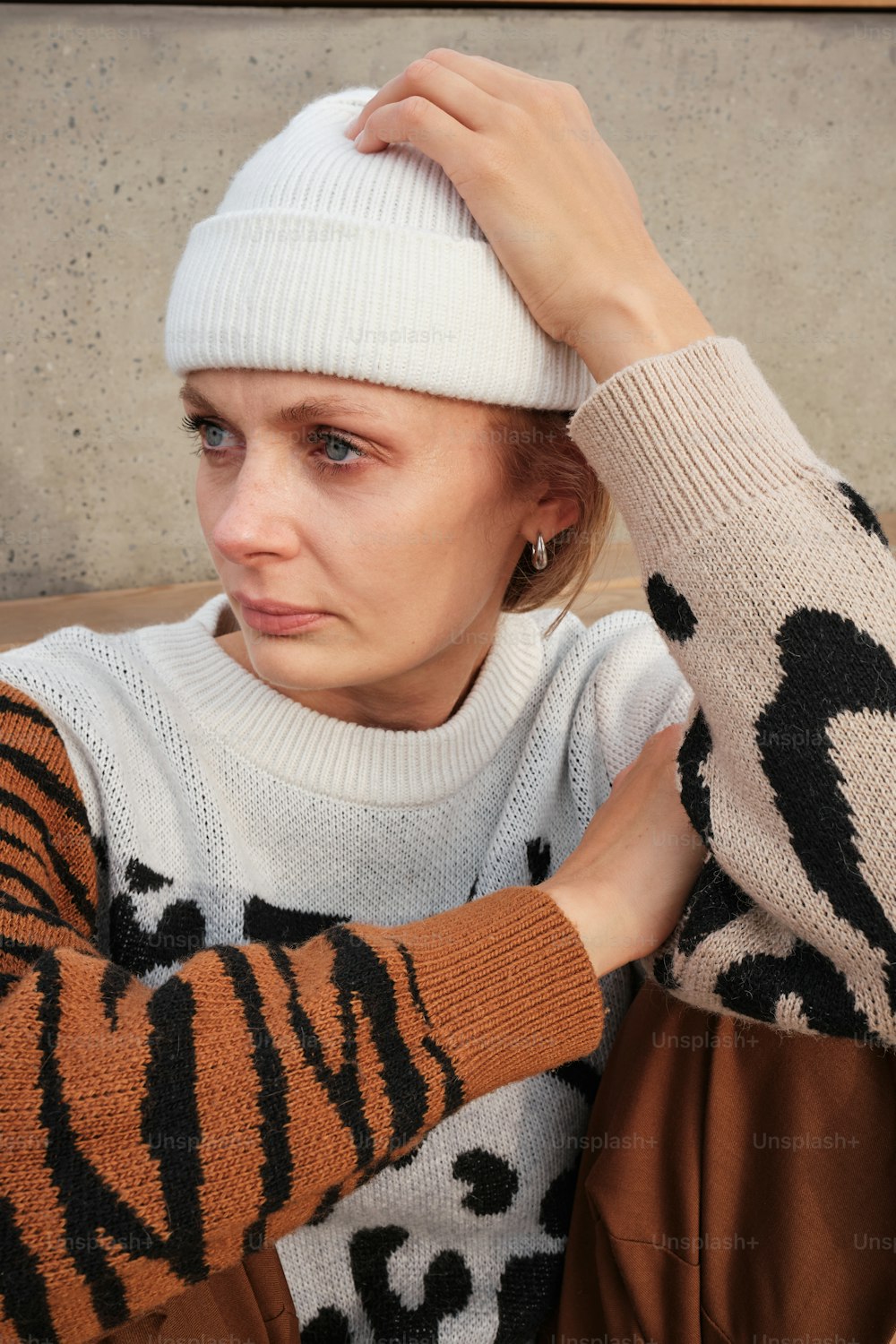 a woman wearing a white hat and sweater