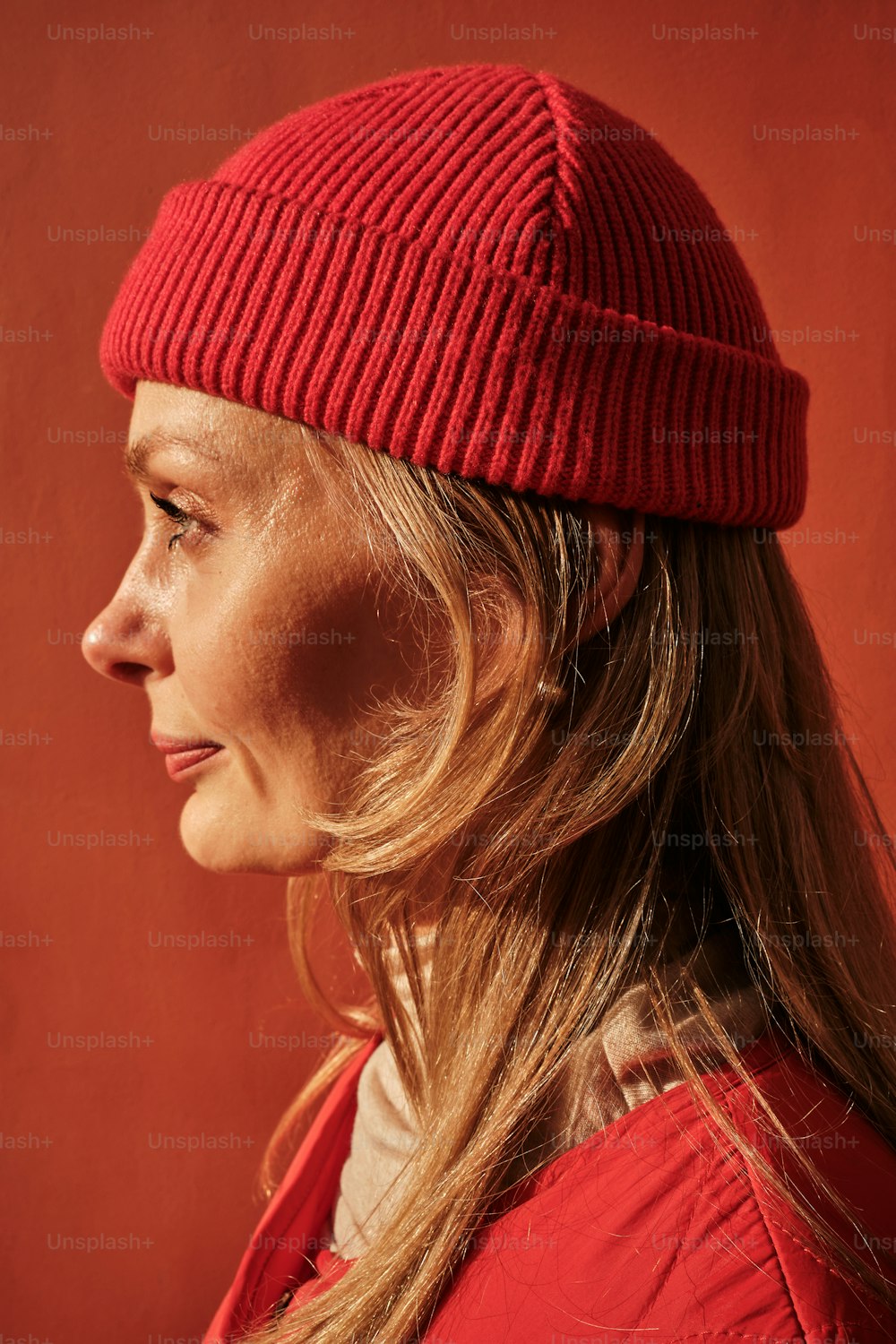 a woman with long hair wearing a red hat