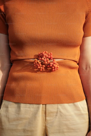 a woman wearing a belt with beads on it