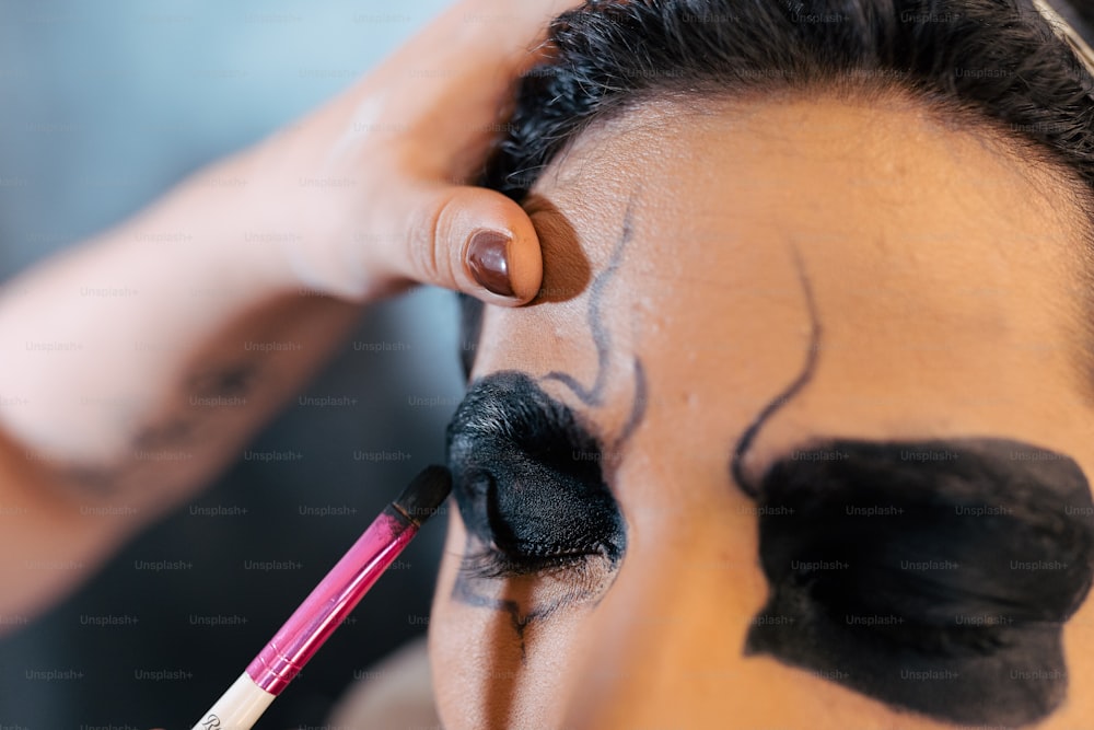 a close up of a person doing makeup