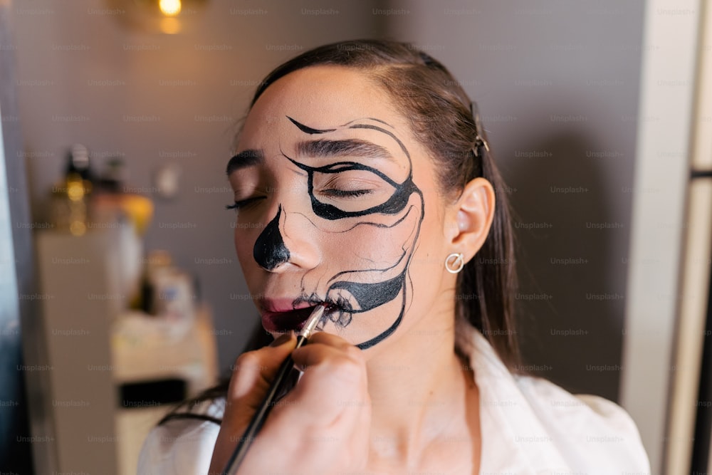 a woman with a black face painted on her face