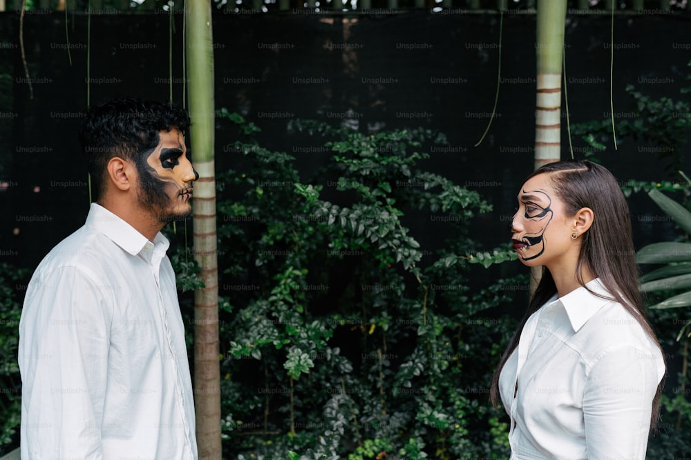 a man and a woman wearing face paint