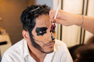 a man with a face painted like a cat