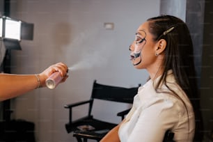 a woman in a white shirt is smoking a cigarette