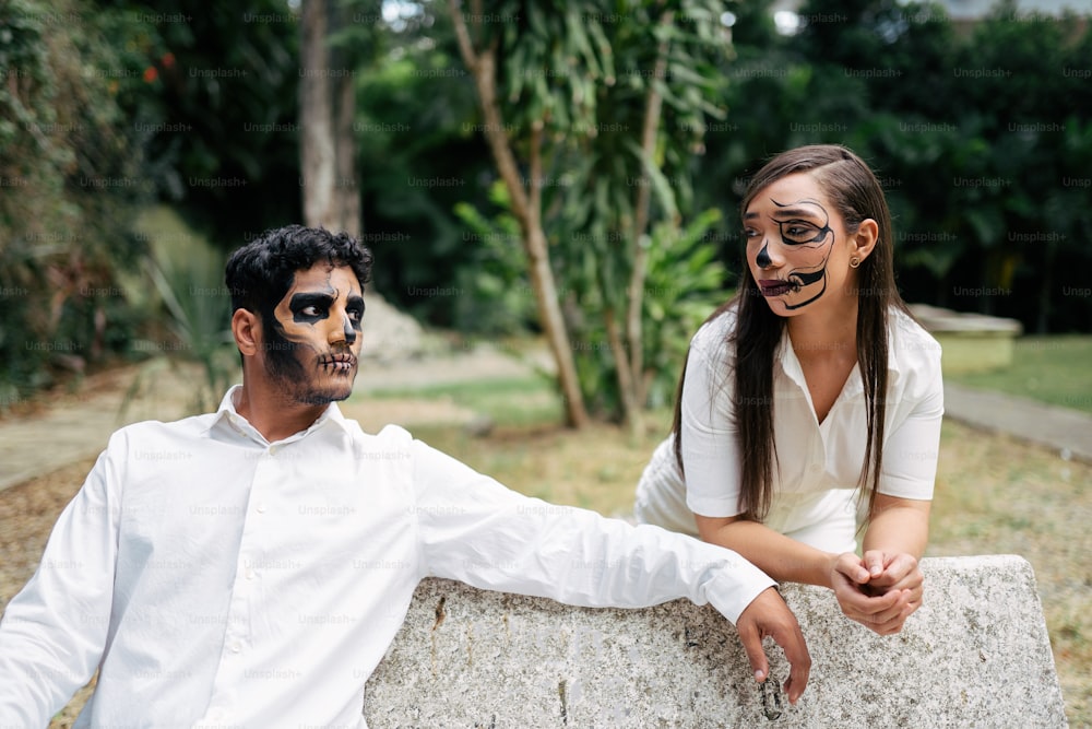 a man and a woman wearing face paint
