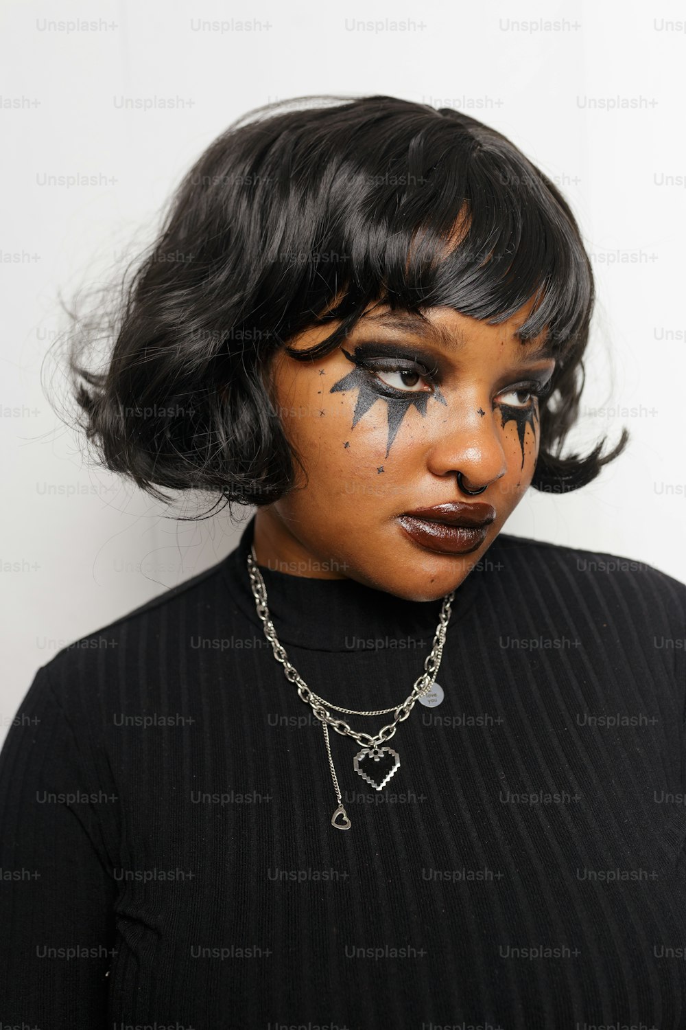 a woman with black makeup and a star on her face