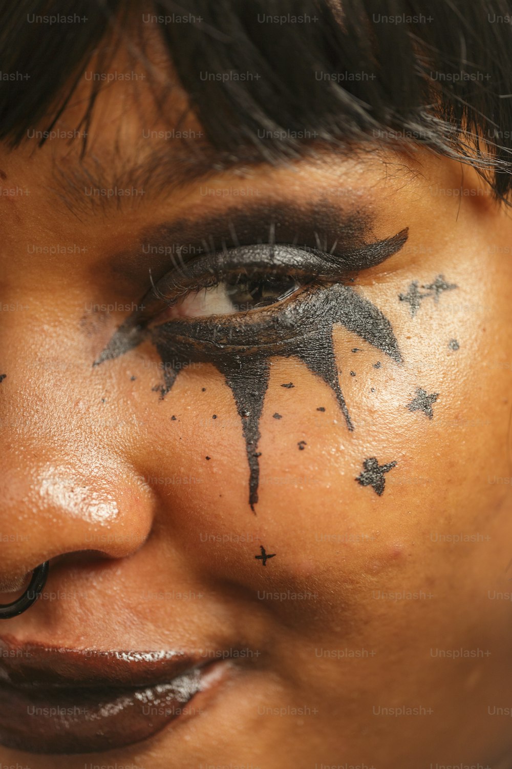 a close up of a person with black makeup
