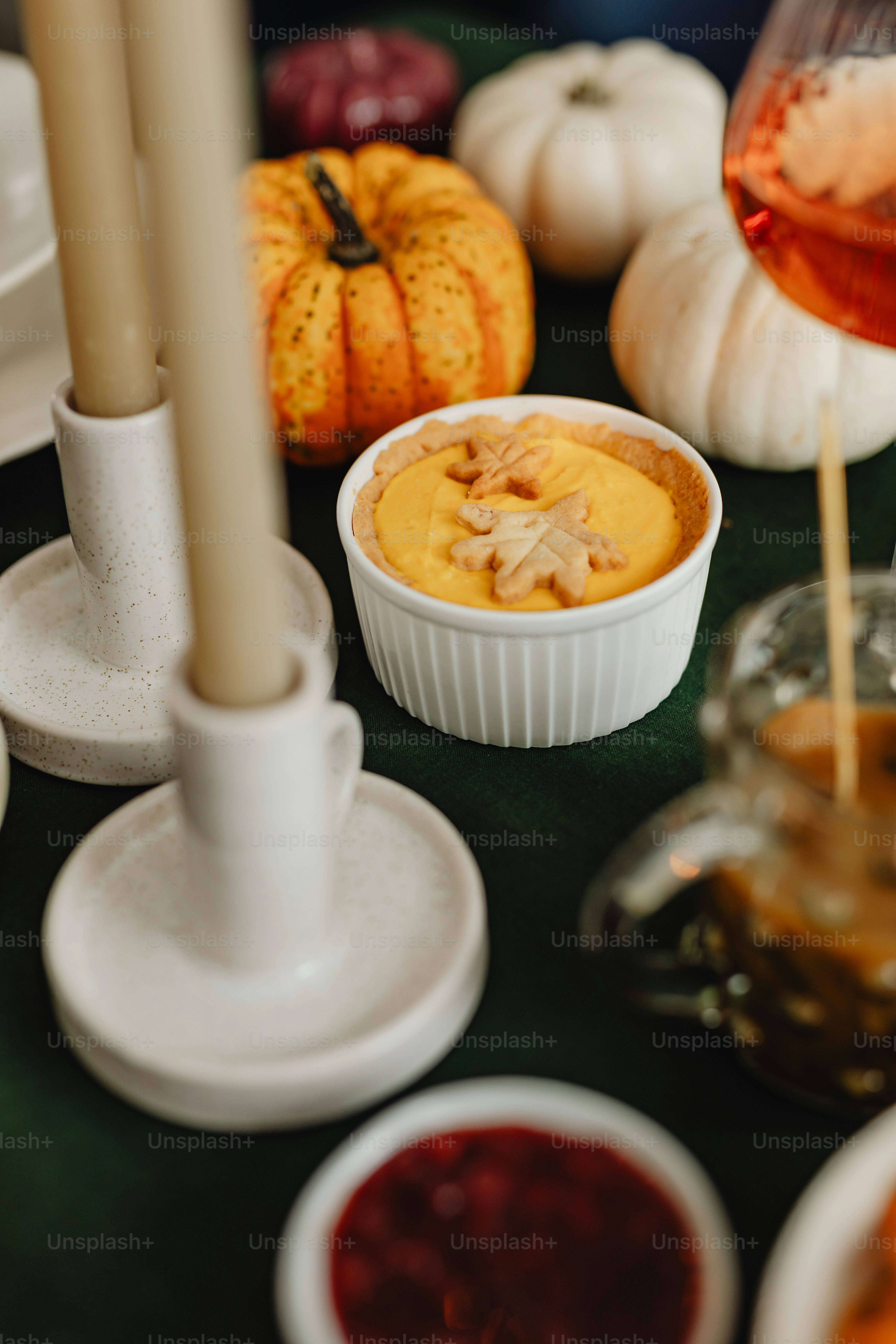 a table topped with white dishes filled with food