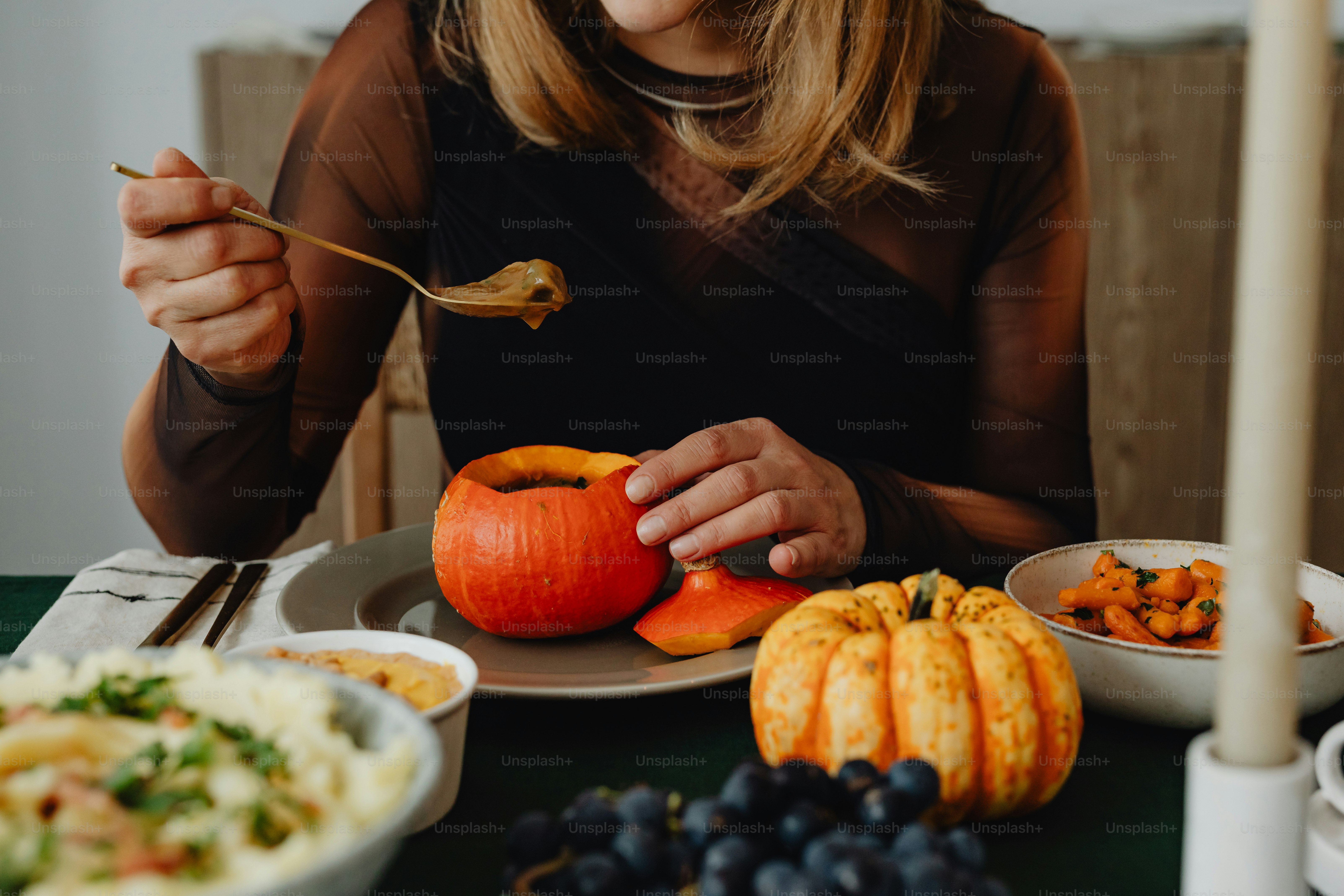 a woman sitting at a table with a plate of food