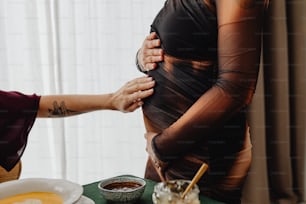 a pregnant woman getting her belly examined by a doctor