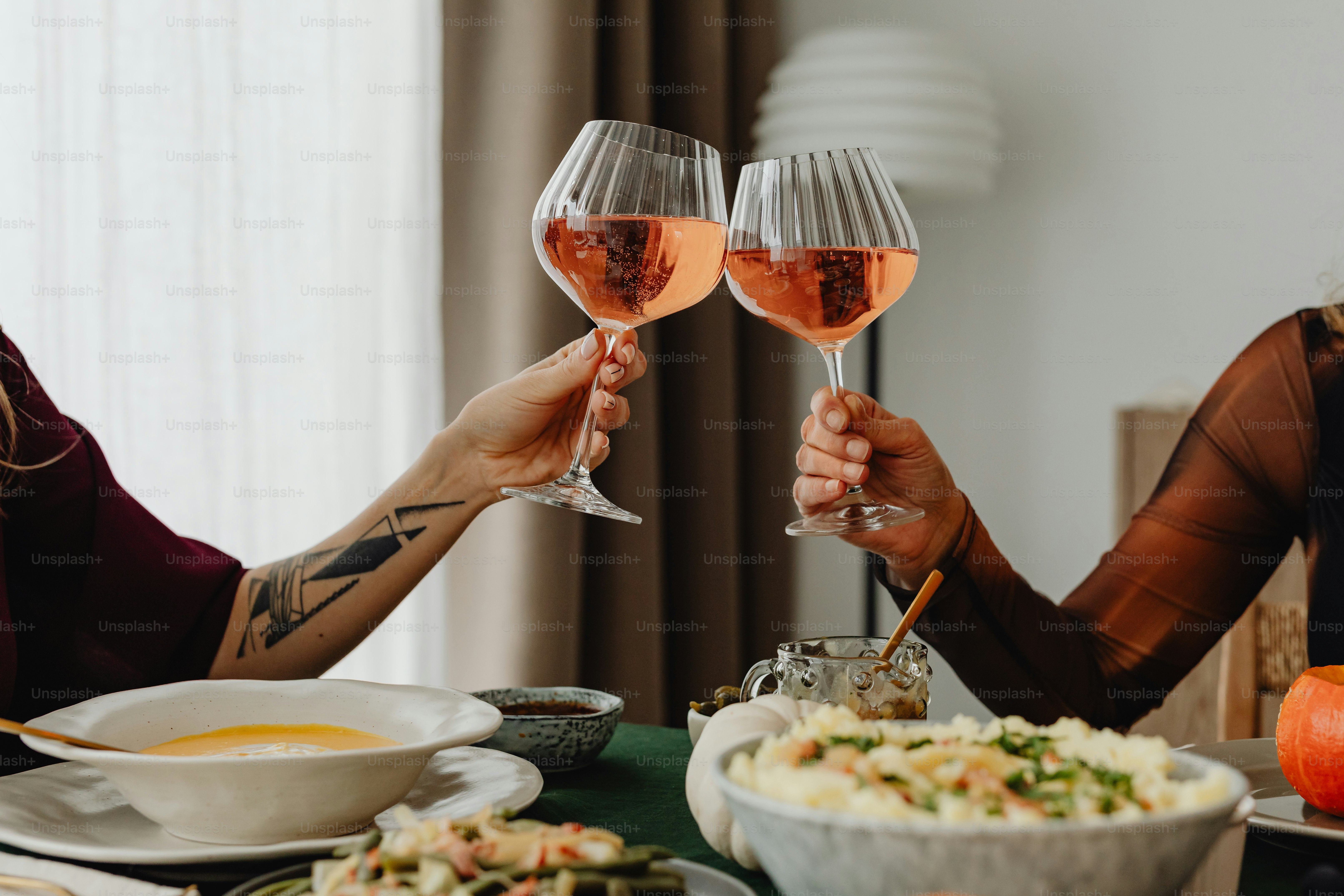 a couple of people that are holding wine glasses