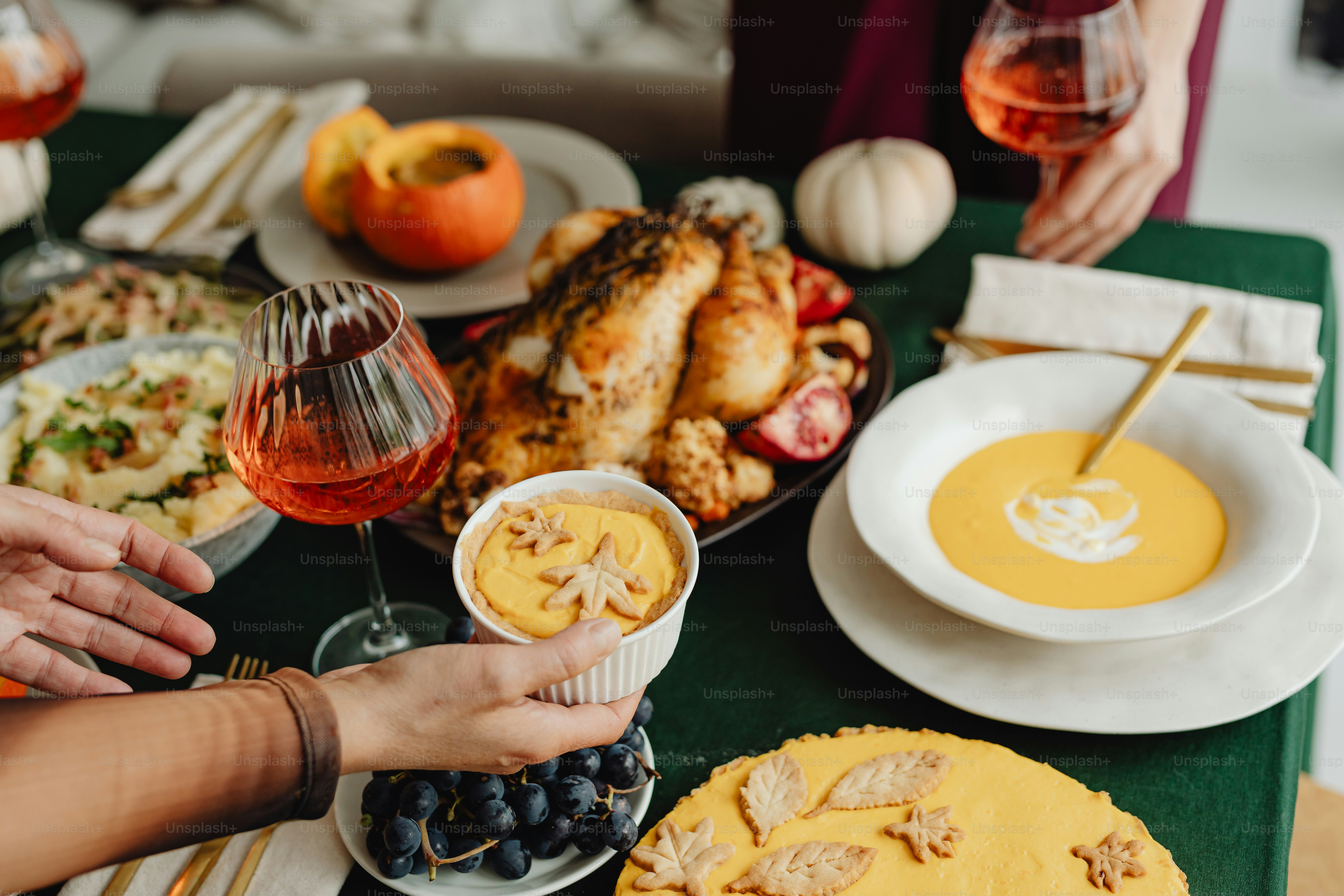 a table filled with plates of food and glasses of wine