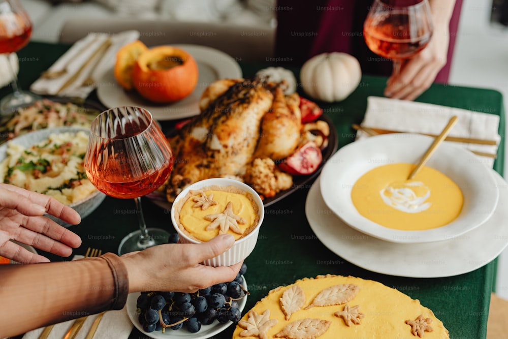 a table filled with plates of food and glasses of wine