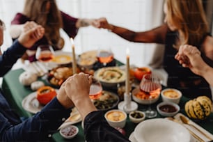 a group of people sitting around a table with food