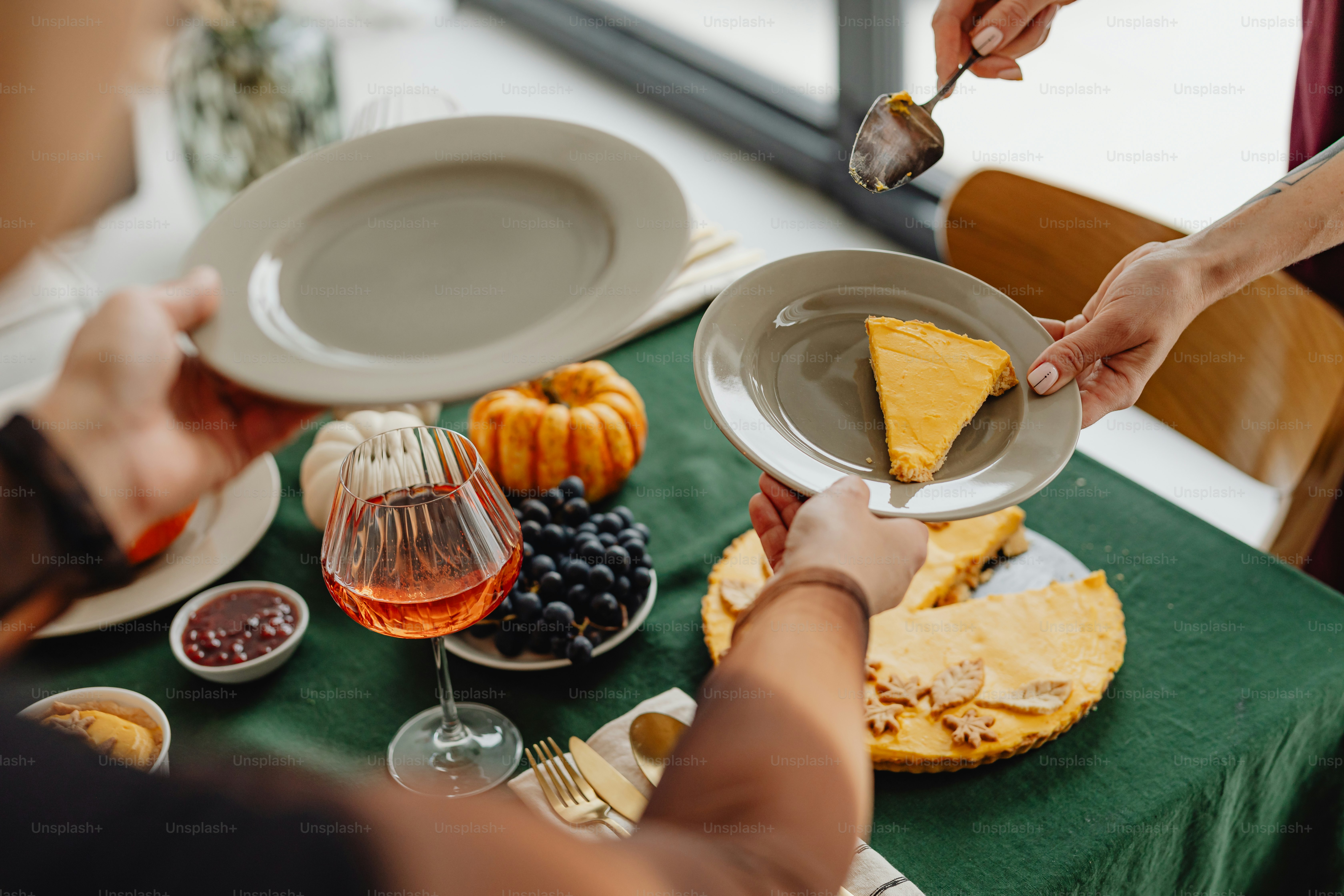A group of people sitting around a table with plates of food photo ...